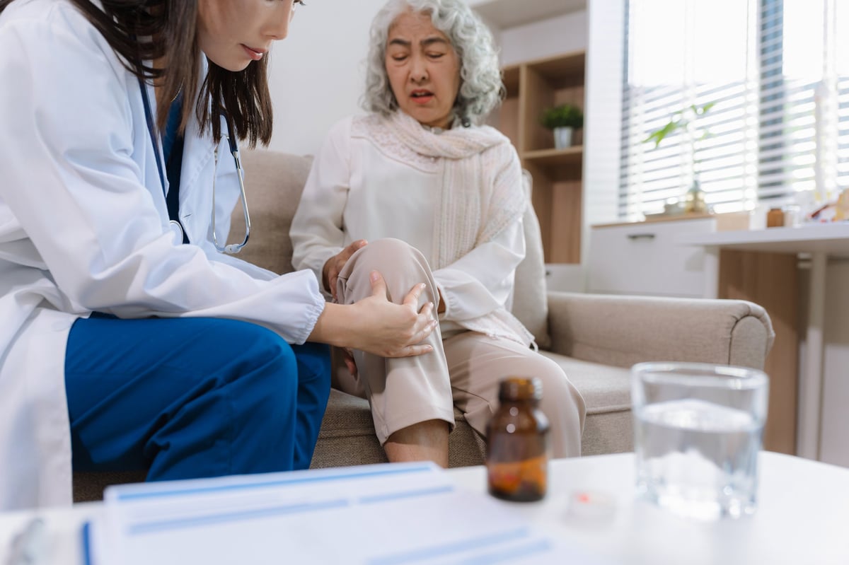 Doctor explaining vein and vascular treatment to patient in medical clinic